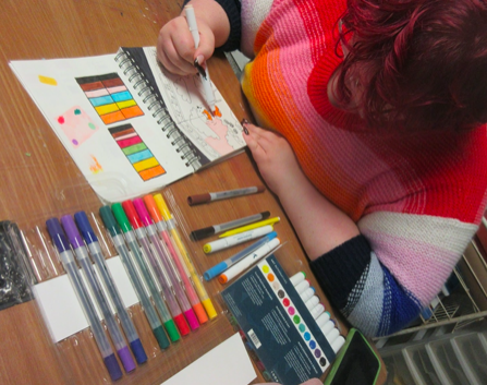 Lillian McMeekin works on her senior project by creating color swatches and different color combinations